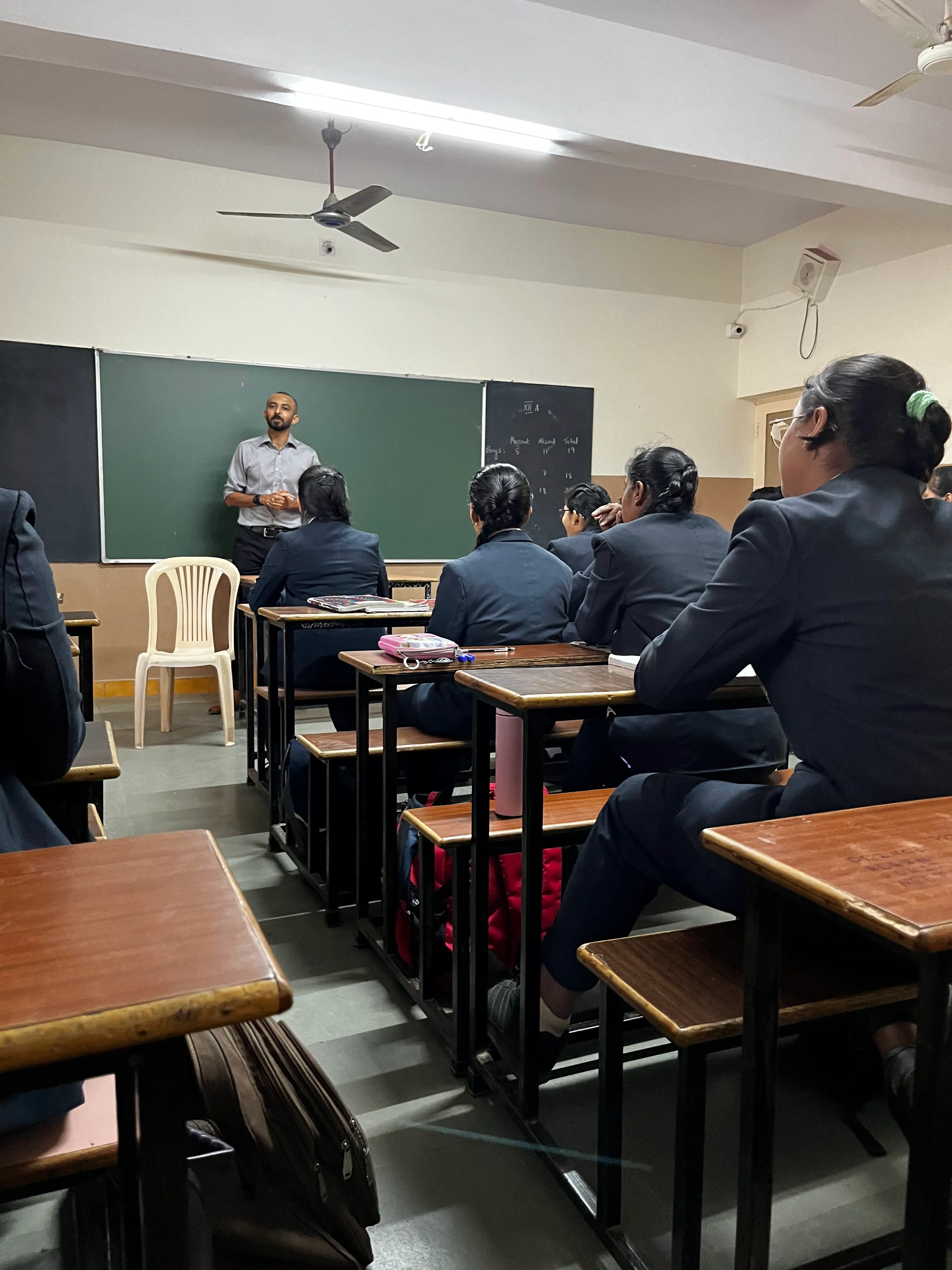 A classroom of students in uniform during one of our sessions, seen from the back of the room