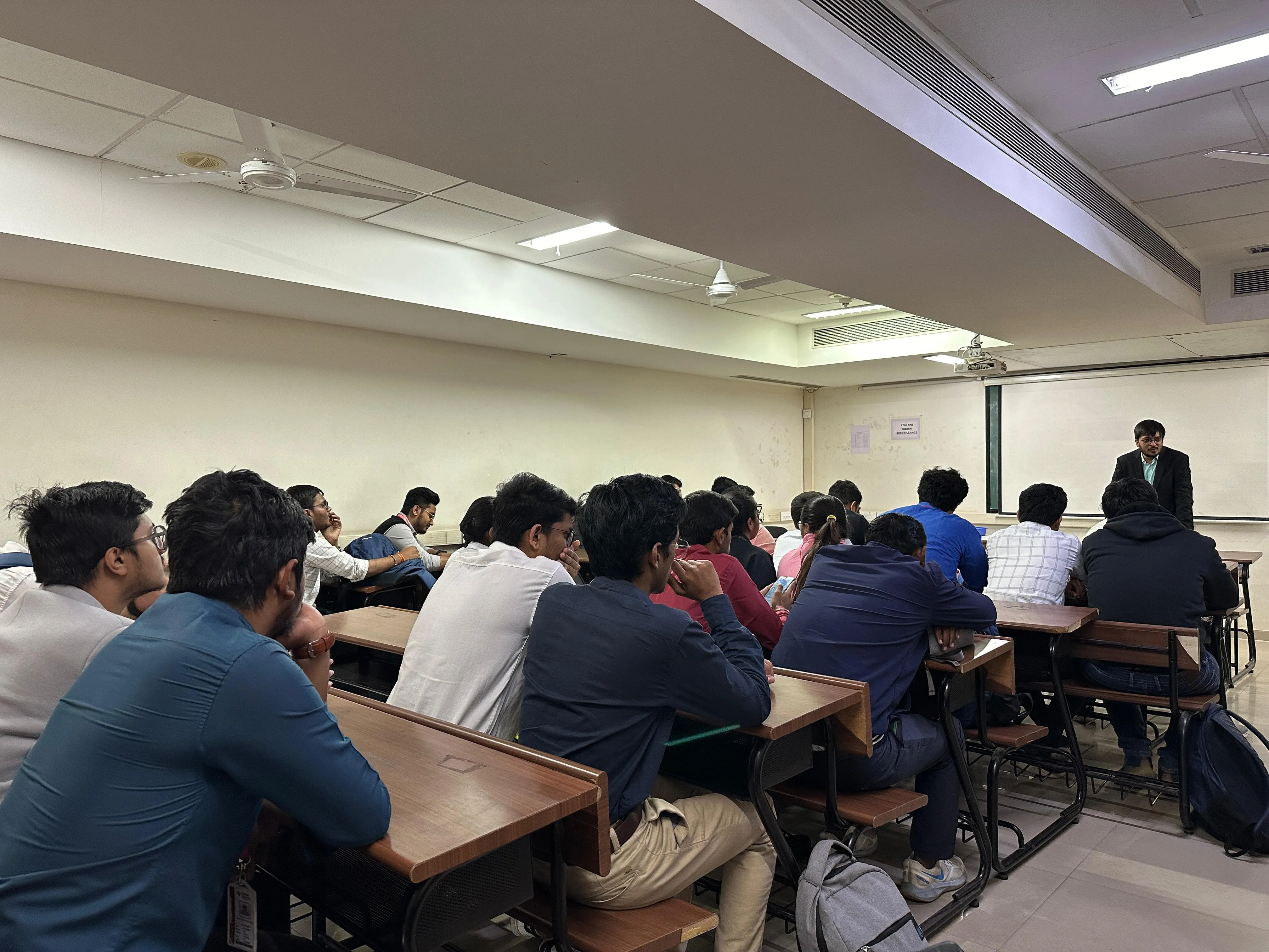 Students filling a classroom from the back rows forward during one of our sessions