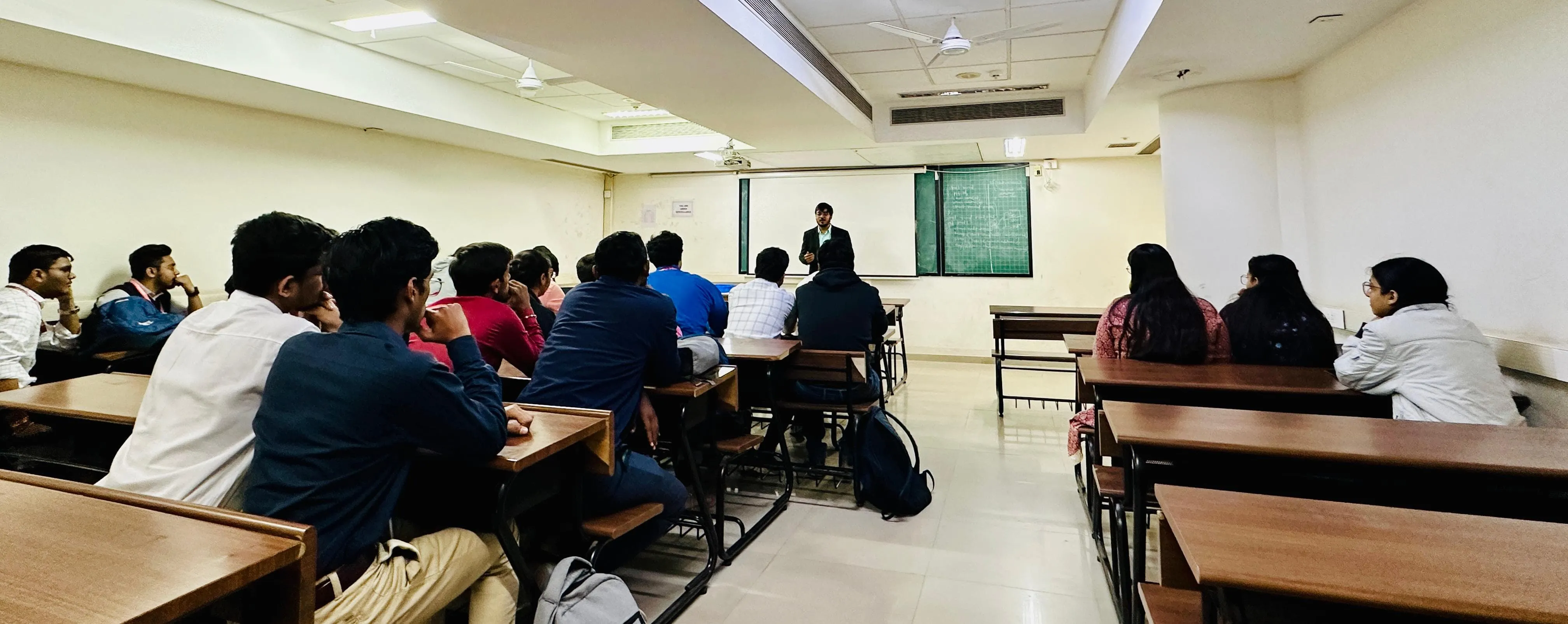 A full room of students seen from the back during one of our campus sessions, facing the speaker at the front