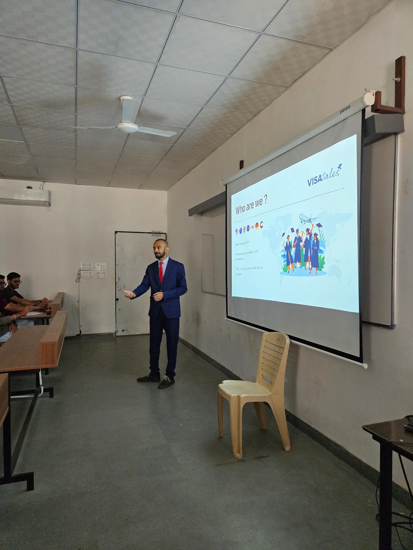 Presenting one of our own slides to students at the front of a classroom