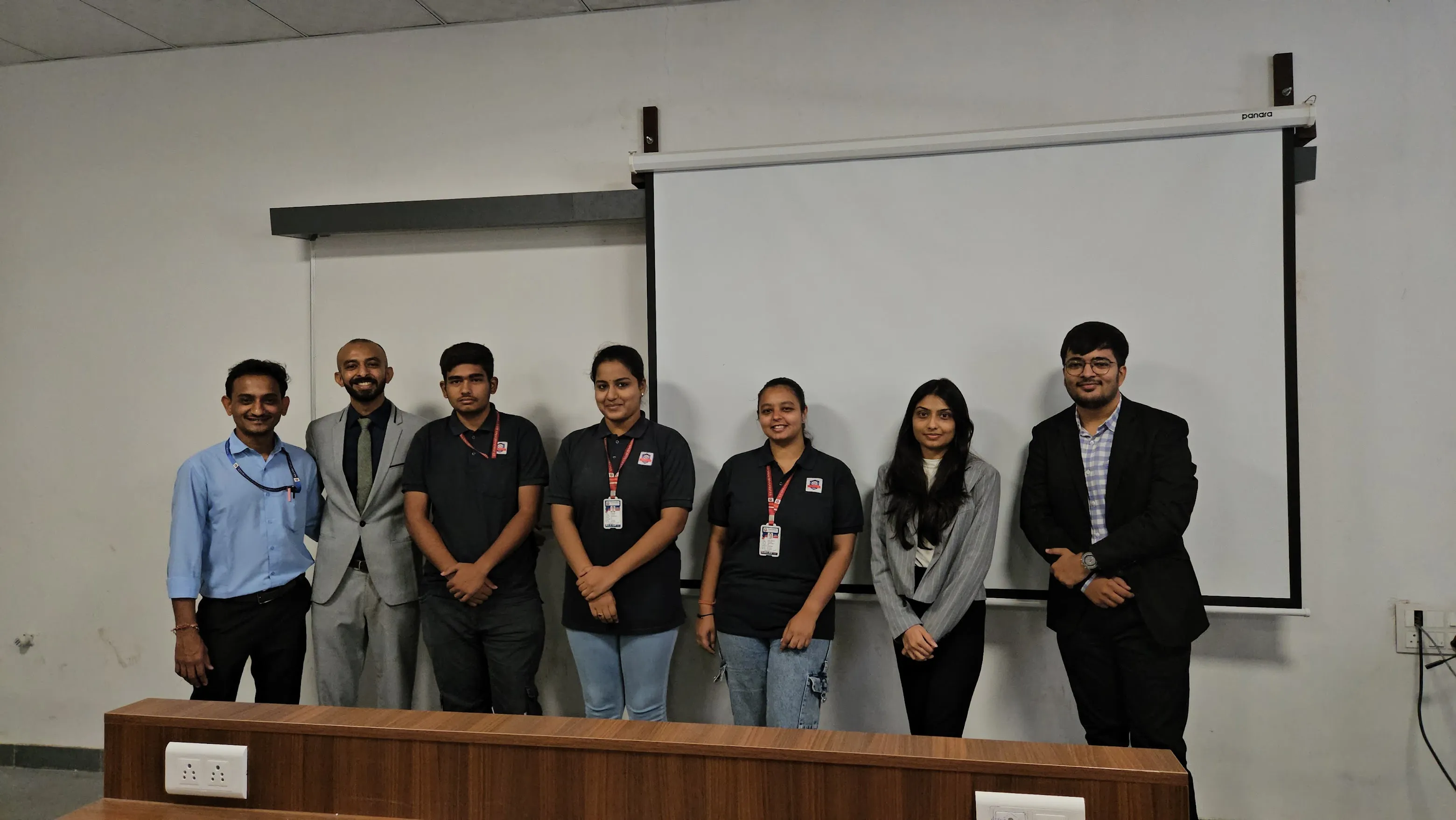 Our team standing with staff from the host institution after a session
